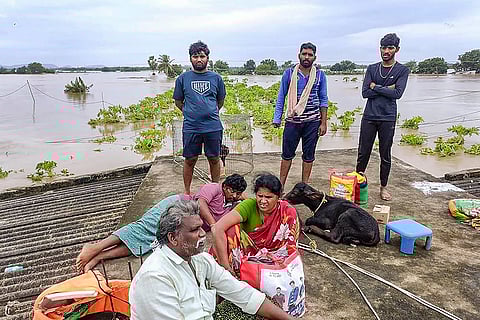 Flood in Vijayawada: People wait on the roof of a house for evacuation